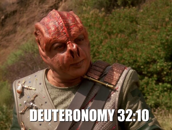 Still from that Star Trek episode, of that Darmok alien guy, with the text "DEUTERONOMY 32:10" along the bottom of the image in the mene-standard Impact font in white all-caps.